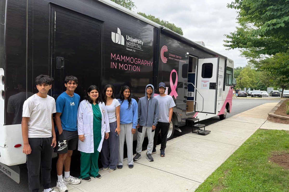 Volunteers beside the mobile mammography unit