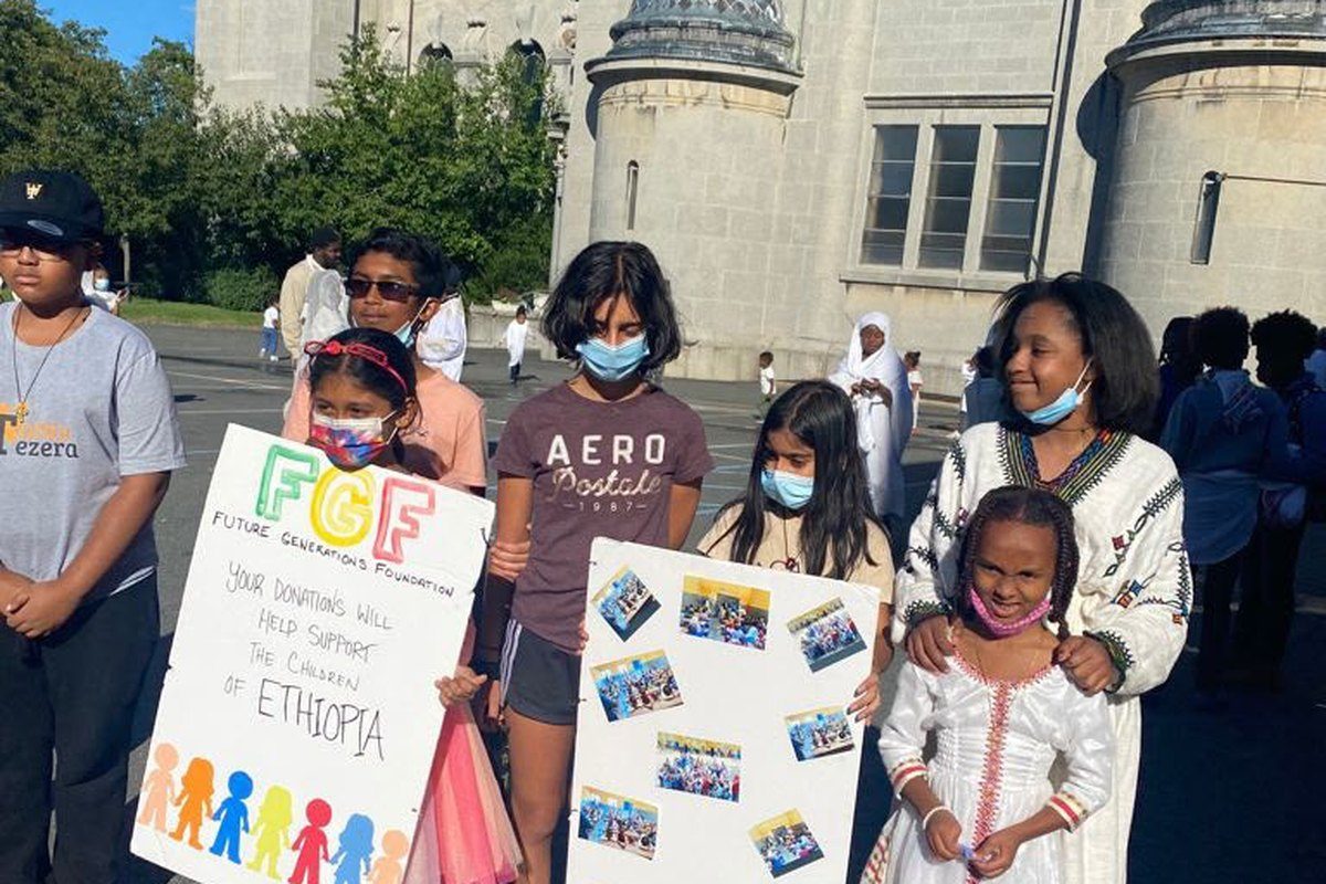 Volunteers with Future Generations Foundation posters for children in Ethiopia