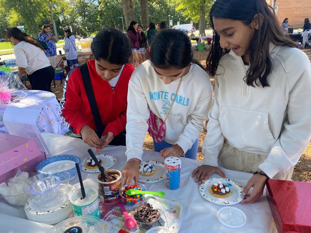 Student volunteers running the cookie decorating table